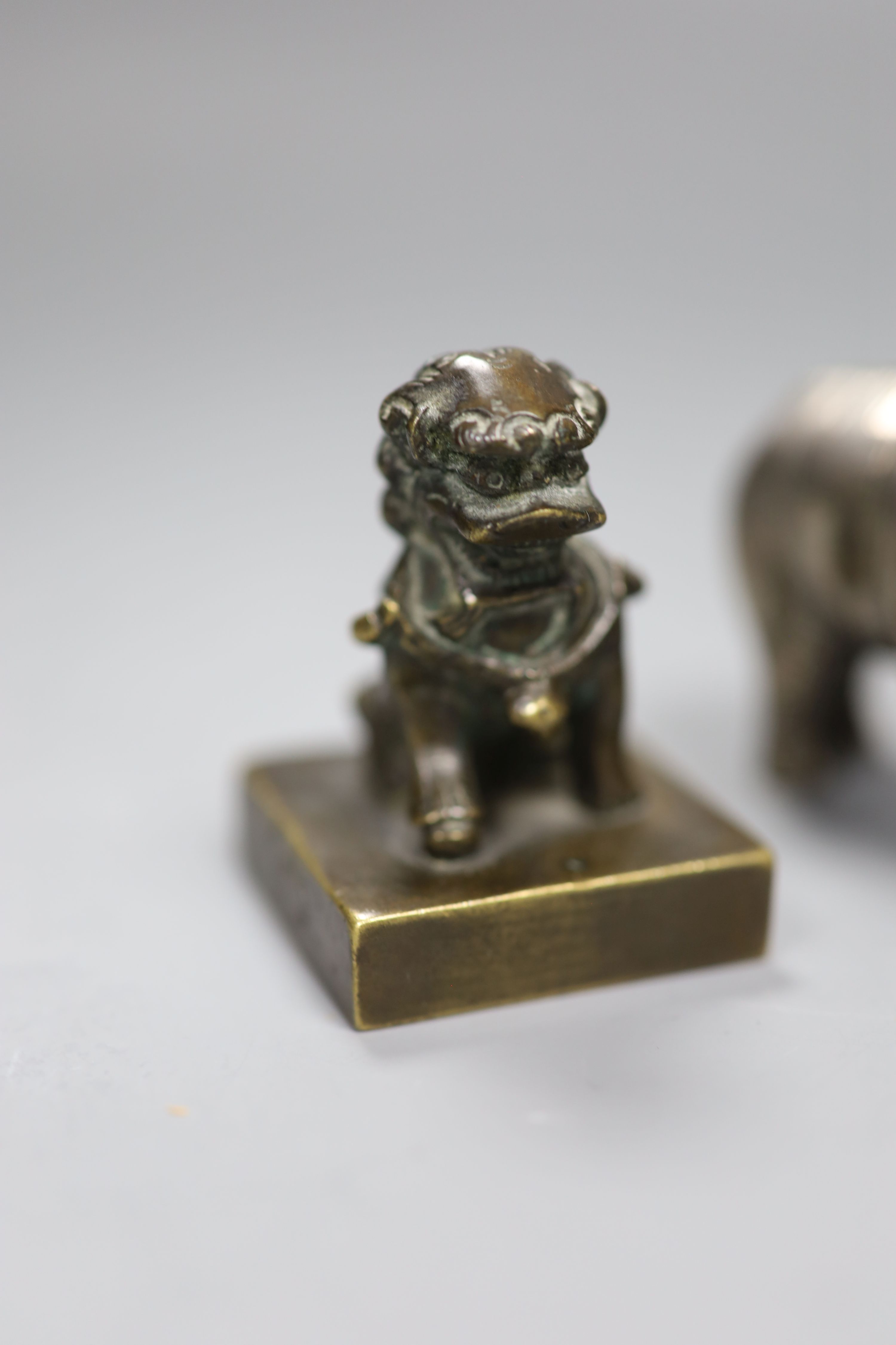 A group of Chinese bronze seals and a white metal elephant